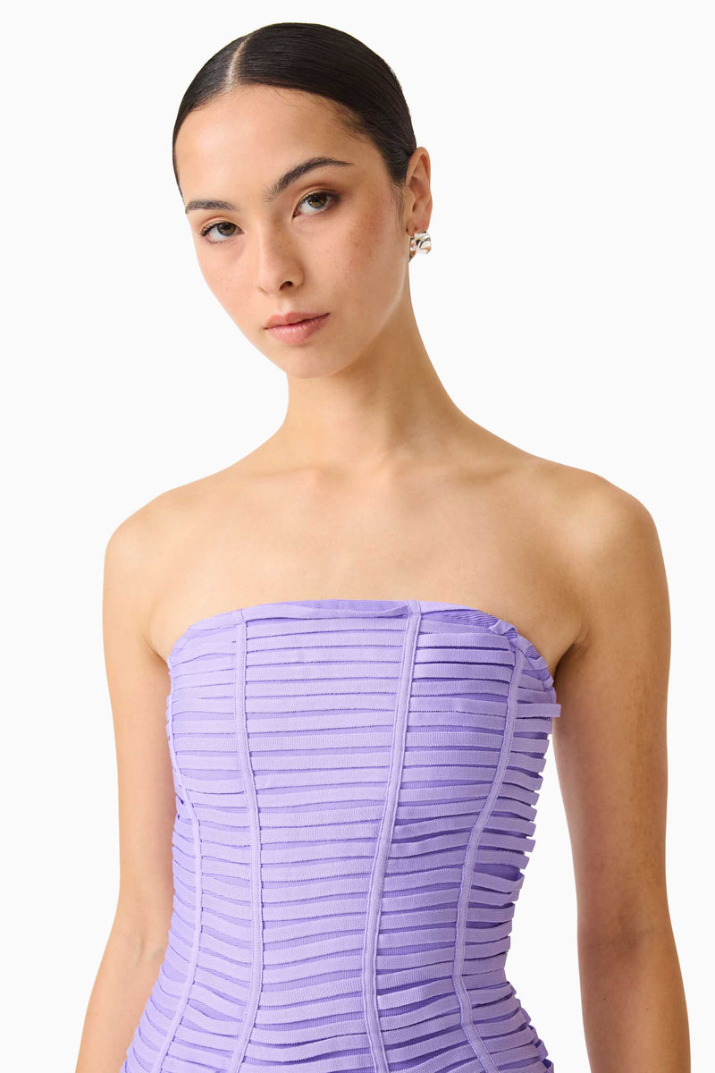 Brunette model wearing the Alya Strapless Mini Dress in Purple close up shot 