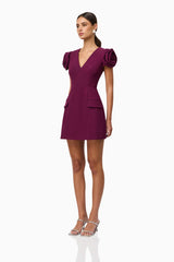 Brunette model wearing Theresa V-Neck Mini Dress in Burgundy side shot