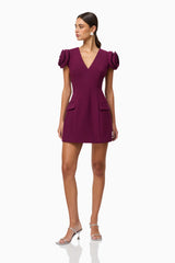 Brunette model wearing Theresa V-Neck Mini Dress in Burgundy posed shot