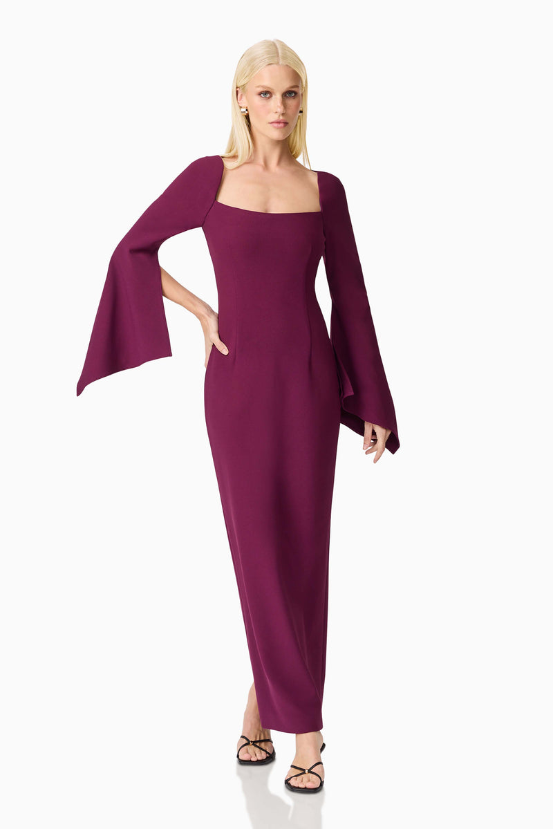 Blonde model wearing the Theresa Long Sleeve Gown in Burgundy posed hand on hip shot