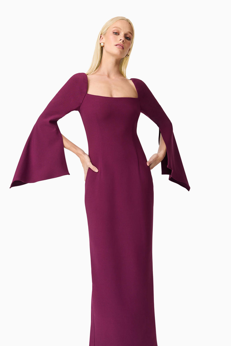 Blonde model wearing the Theresa Long Sleeve Gown in Burgundy close up hand on hips shot