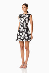 Brunette model wearing the Carol Tulip Mini Dres in Black & White side shot
