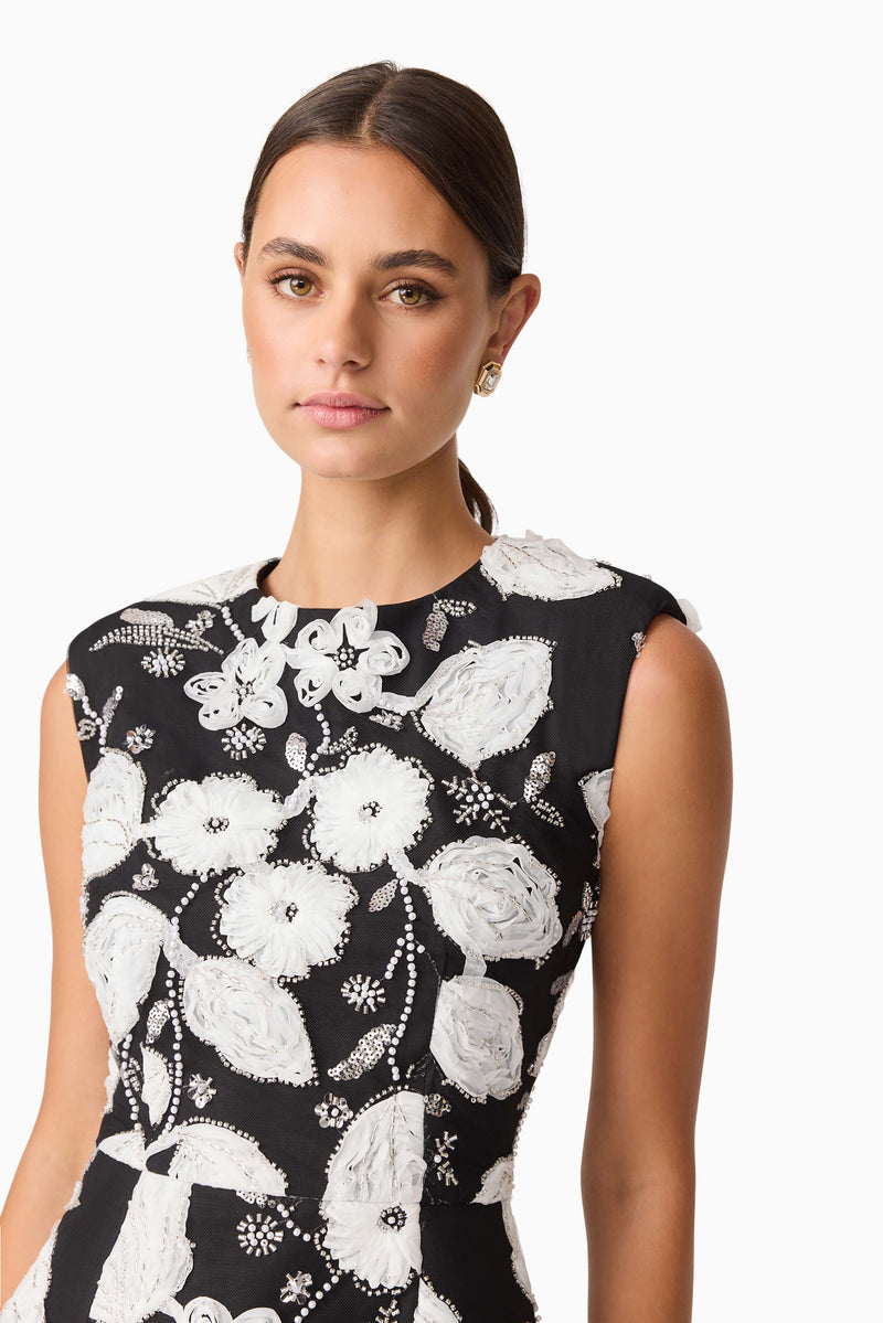 Brunette model wearing the Carol Tulip Mini Dres in Black & White close up shot