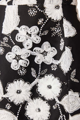 Brunette model wearing the Carol Tulip Mini Dres in Black & White detail shot