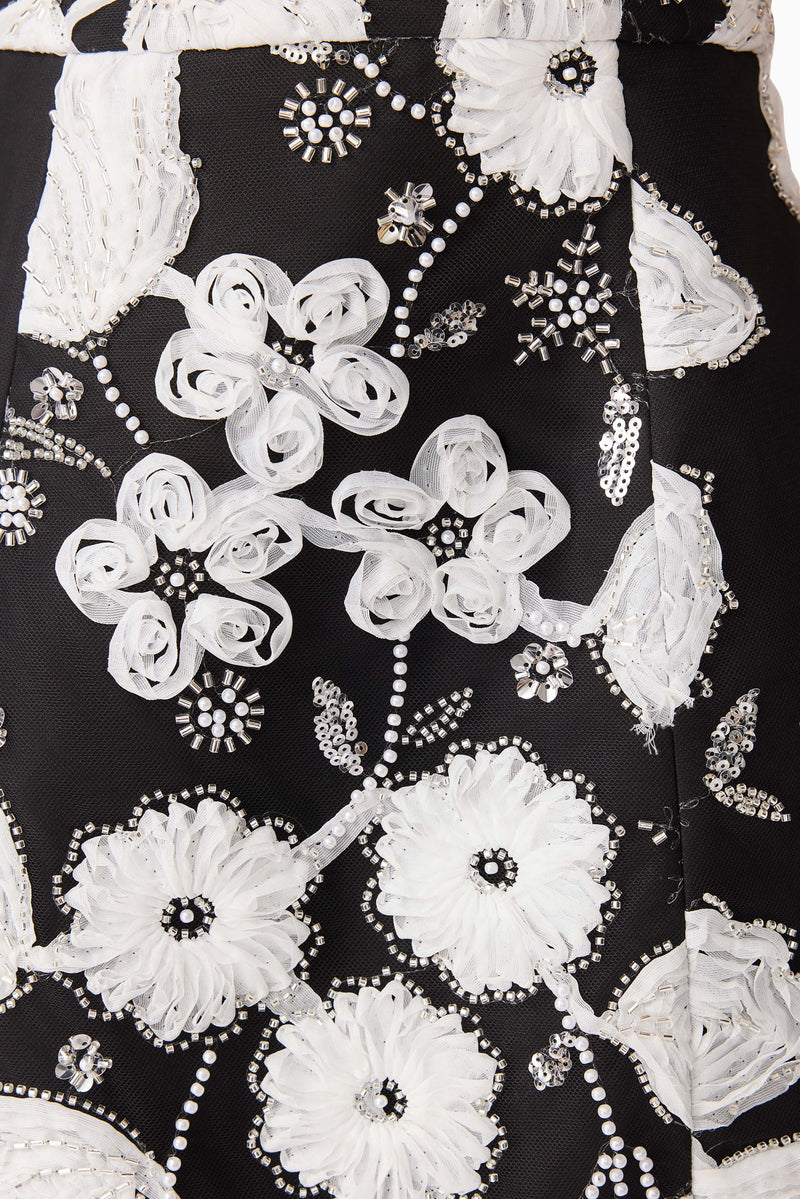 Brunette model wearing the Carol Tulip Mini Dres in Black & White detail shot