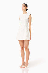 Brunette model wearing Carol Tulip Mini Dress in White side shot