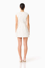 Brunette model wearing Carol Tulip Mini Dress in White back shot