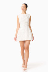 Brunette model wearing Carol Tulip Mini Dress in White posed shot