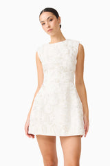 Brunette model wearing Carol Tulip Mini Dress in White close up posed shot