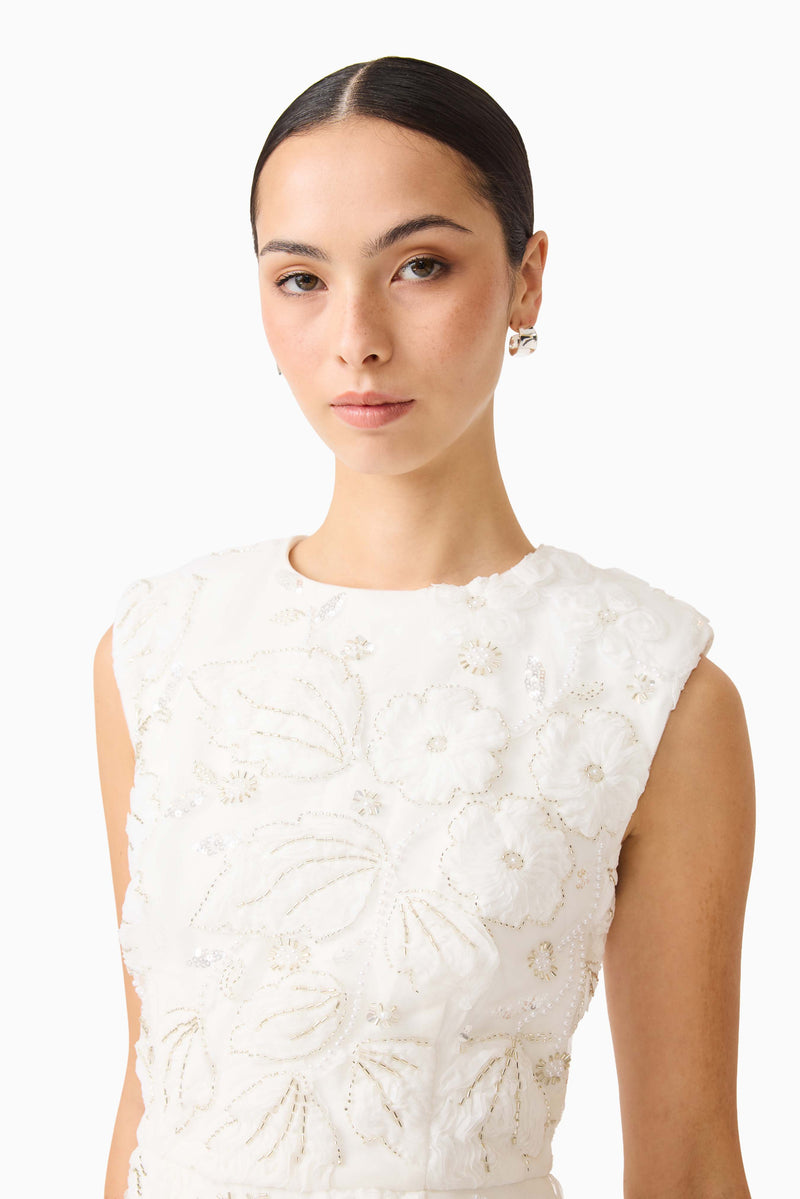 Brunette model wearing Carol Tulip Mini Dress in White close up shot
