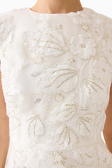 Brunette model wearing Carol Tulip Mini Dress in White detail shot