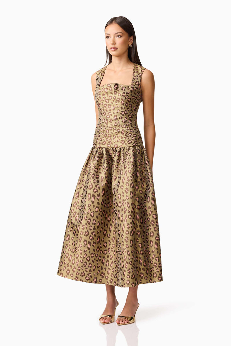 Brunette model wearing Elara Drop Waist Dress in Leopard Print side shot