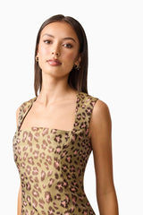 Brunette model wearing Elara Drop Waist Dress in Leopard Print close up shot