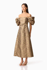Brunette model wearing the Elara Off The Shoulder Mini Dress in Leopard Print side shot