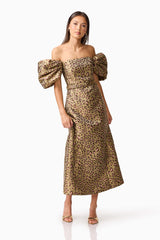 Brunette model wearing the Elara Off The Shoulder Mini Dress in Leopard Print posed shot