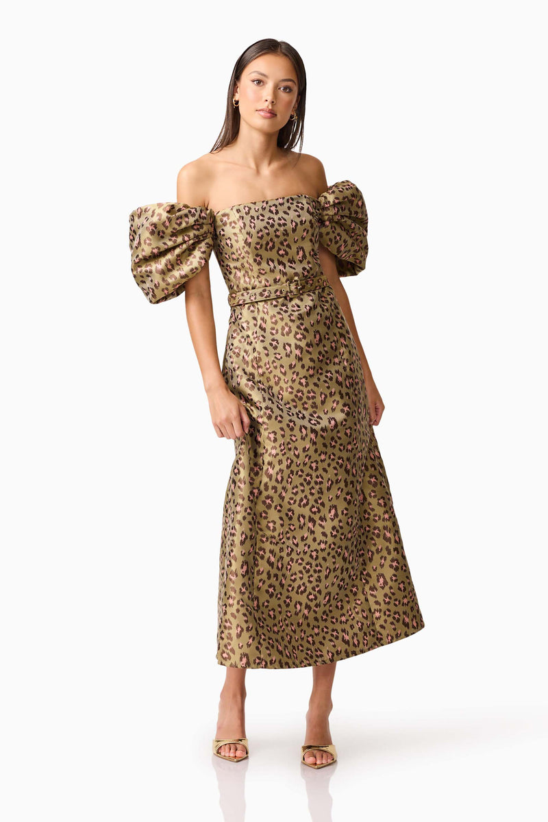 Brunette model wearing the Elara Off The Shoulder Mini Dress in Leopard Print posed shot