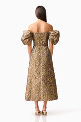 Brunette model wearing the Elara Off The Shoulder Mini Dress in Leopard Print back shot