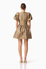 Brunette model wearing the Elara Romper Mini Dress in Leopard Print back shot