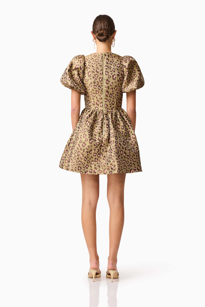 Brunette model wearing the Elara Romper Mini Dress in Leopard Print back shot