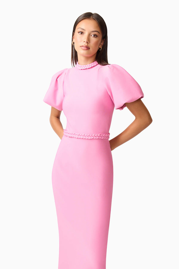 Brunette model wearing Coralene Puff Sleeve Midi Dress in Pink hands behind back shot
