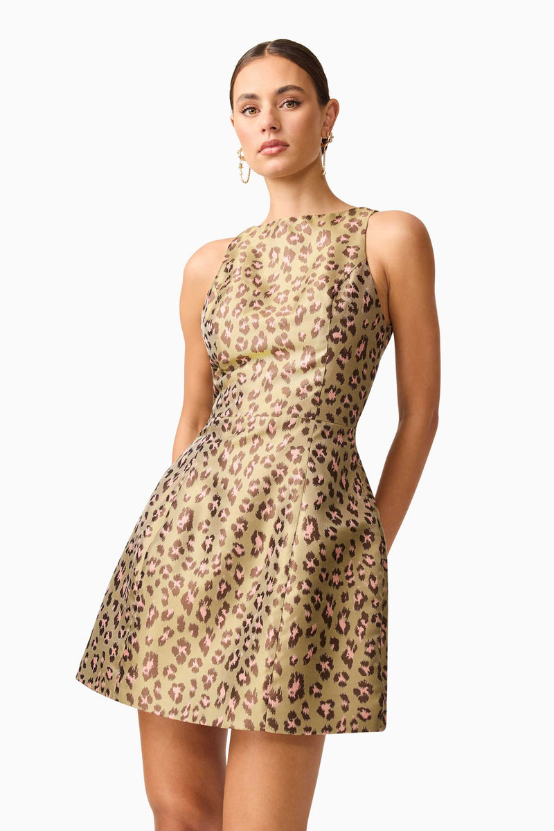 Brunette model wearing Elara Tulip Mini Dress in Leopard Print close up posed shot