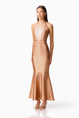 Brunette Model wearing the Rhian Halter Gown in Orange Side Shot
