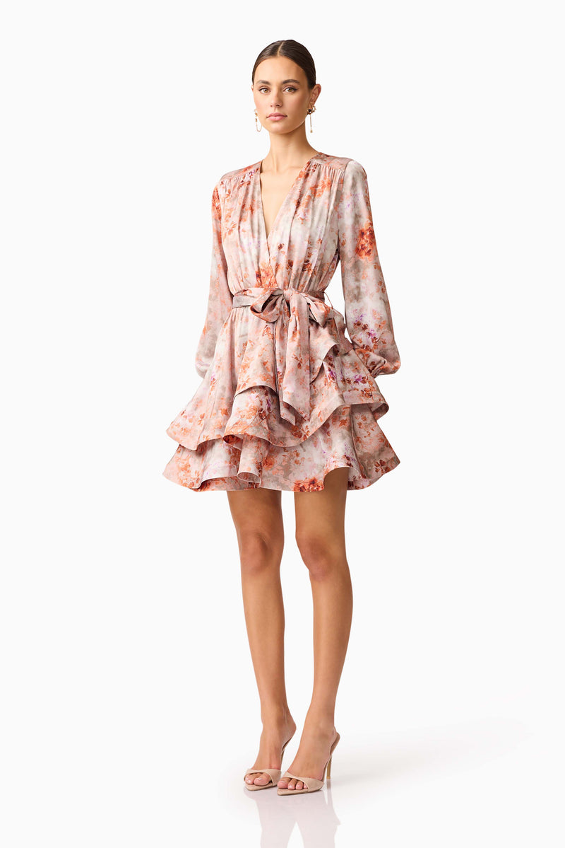 Brunette model wearing the Piper Long Sleeve Mini Dress in Orange Floral Side Shot