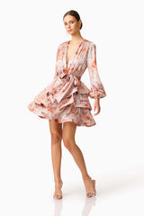 Brunette model wearing the Piper Long Sleeve Mini Dress in Orange Floral Posed Shot