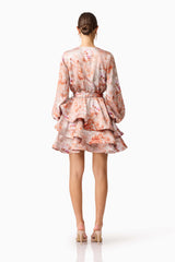 Brunette model wearing the Piper Long Sleeve Mini Dress in Orange Floral Back Shot