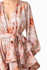 Brunette model wearing the Piper Long Sleeve Mini Dress in Orange Floral Detail Shot