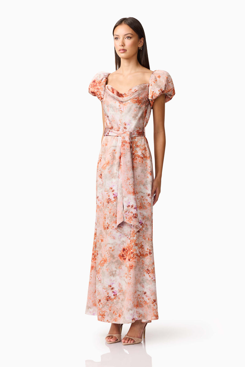 Brunette model wearing the Piper Puff Sleeve Maxi Dress in Orange Floral Side Shot