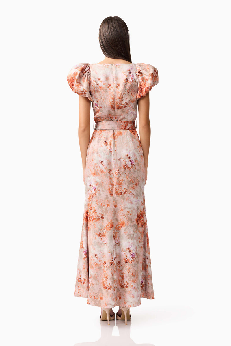 Brunette model wearing the Piper Puff Sleeve Maxi Dress in Orange Floral Back Shot