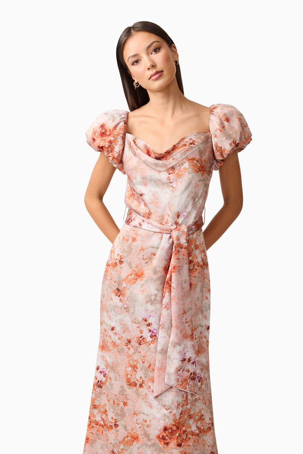 Brunette model wearing the Piper Puff Sleeve Maxi Dress in Orange Floral Close Up Shot