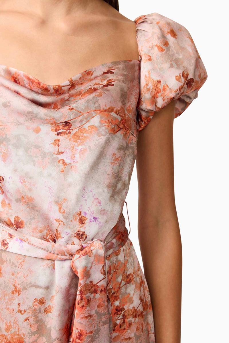 Brunette model wearing the Piper Puff Sleeve Maxi Dress in Orange Floral Detail Shot