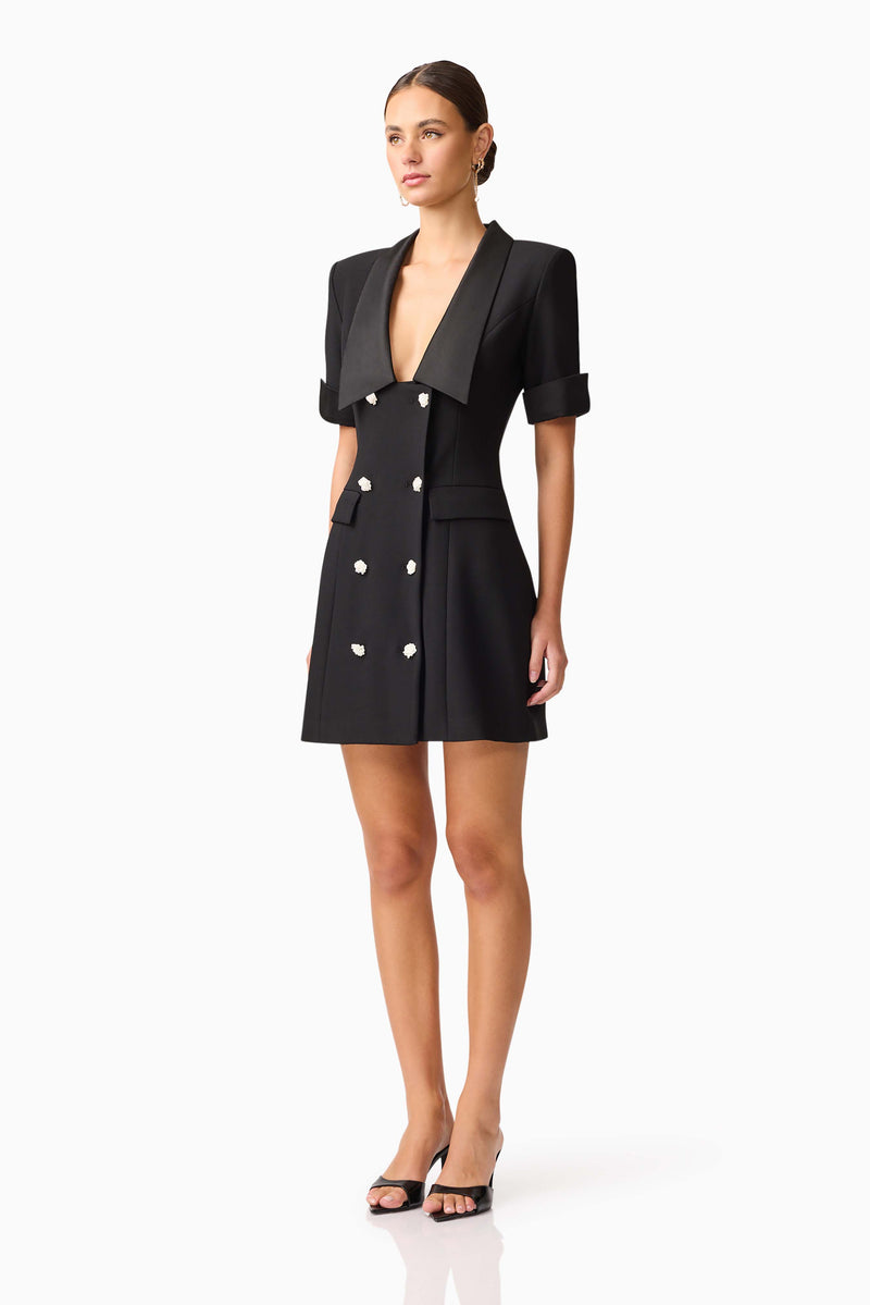 Brunette model wearing Ruby Short Sleeve Blazer Dress in Black side shot