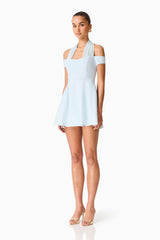 Brunette model wearing the Ruby Halter Mini Dress in Blue side shot
