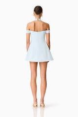Brunette model wearing the Ruby Halter Mini Dress in Blue back shot