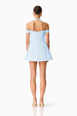 Brunette model wearing Ruby Halter Mini Dress in Blue back shot 
