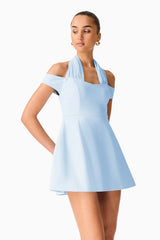 Brunette model wearing Ruby Halter Mini Dress in Blue close up posed shot 