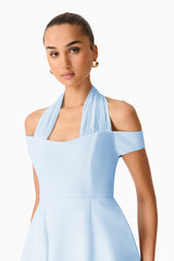 Brunette model wearing Ruby Halter Mini Dress in Blue close up shot 