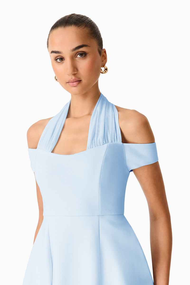 Brunette model wearing Ruby Halter Mini Dress in Blue close up shot 