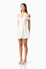 Brunette model wearing Ruby Halter Mini Dress in White side Shot