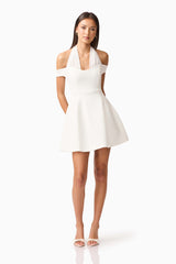 Brunette model wearing Ruby Halter Mini Dress in White posed Shot
