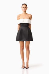 Brunette model wearing Sorrel Off the Shoulder Mini Dress in Black & White posed shot