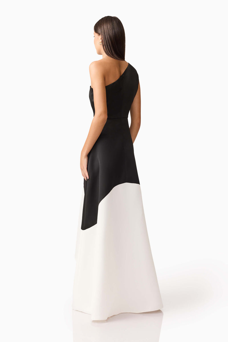 Brunette model wearing Sorrel One Shoulder Gown in Black & White back side shot