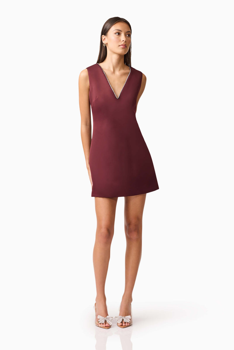 Brunette model wearing Livia Shift Mini Dress in Red looking away shot