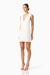 Brunette model wearing Livia Shift Mini Dress in white side shot