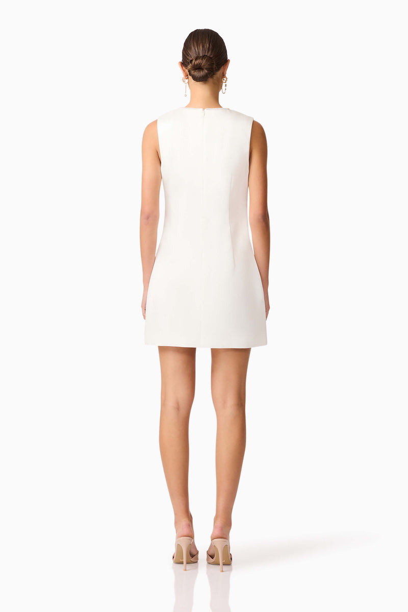 Brunette model wearing Livia Shift Mini Dress in white back shot