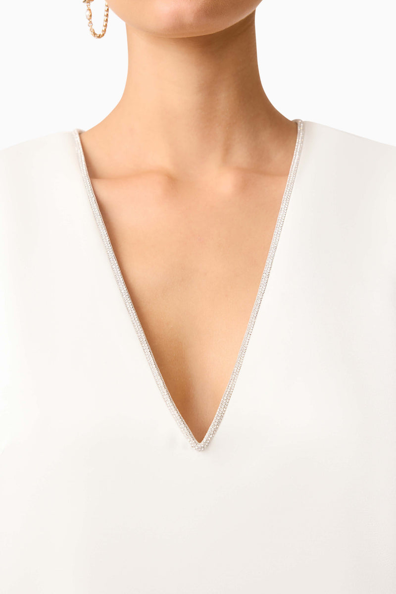 Brunette model wearing Livia Shift Mini Dress in white detail shot