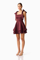 Brunette model wearing Livia Tiered Mini Dress in Red side shot